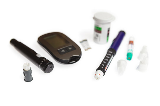 Diabetic set of lancet with spare needles, glucometer, strips, box of spare strips, pen injector, spare insulin and pen needles isolated on white background