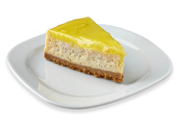 Slice of cheese cake with lemon in porcelain plate isolated on white background. including clipping path