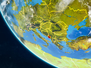 Montenegro on planet Earth from space with country borders. Very fine detail of planet surface and clouds.
