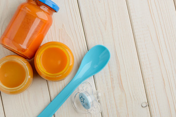Jarred puree, spoon and pacifier
