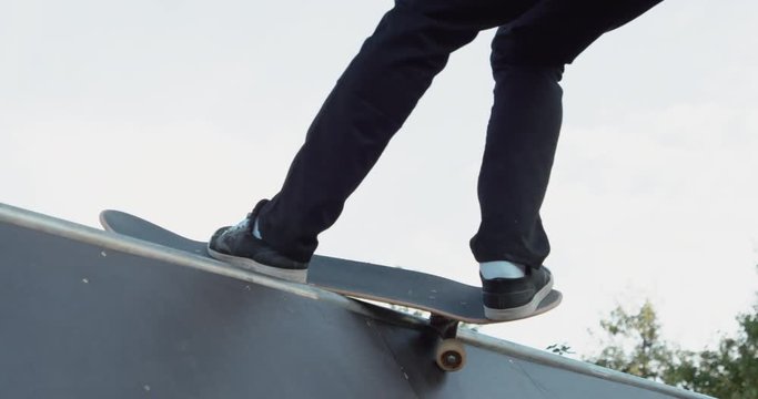 Young adult skateboarding halfpipe 4k super slow motion