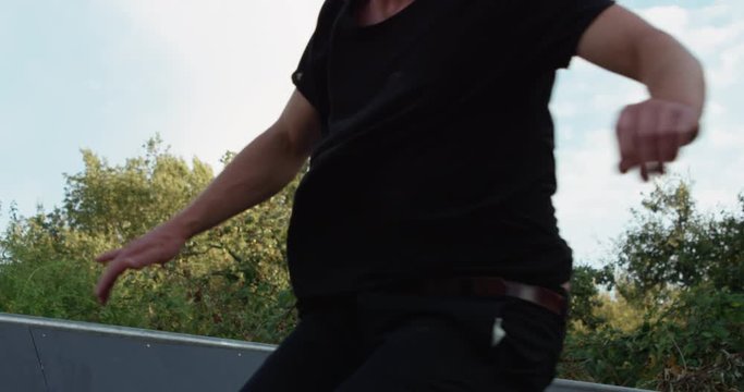 Young adult skateboarding halfpipe 4k super slow motion