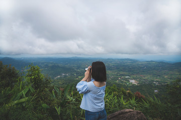 Happy young cute asian Japanese girl hipster backpack photography women taking a photo  at beautiful sky mountains scenery views 