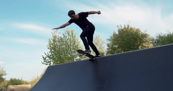Young adult skateboarding halfpipe 4k super slow motion