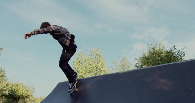 Young adult skateboarding halfpipe 4k super slow motion