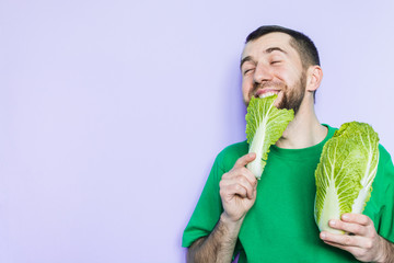 Young man biting on a leaf of Beijing napa cabbage, doubt face expression. Light purple background.