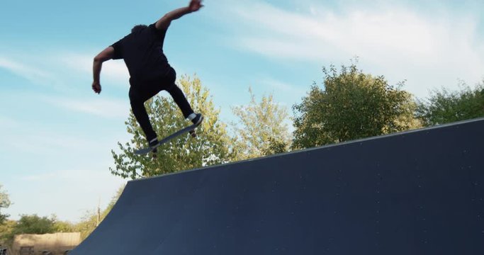 Young adult skateboarding halfpipe 4k super slow motion