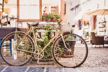 Fototapeta na wymiar Old vintage retro bicycle with beautiful street at the background. Vacations in Europe. 