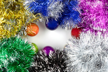 Background for writing congratulations For Christmas and New Year with a picture of tinsel, a Christmas tree, multi-colored boxes with gifts, balls and silver stars on a chain.
