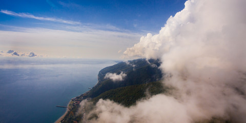 Obraz premium flight near the wall of clouds, free flight. Wall of clouds, blue sky and sea.