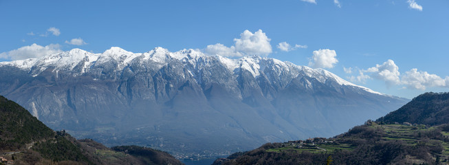 Panoramic view from Vesio village on Monte Baldo mountain range and Garda Lake on a clear spring day