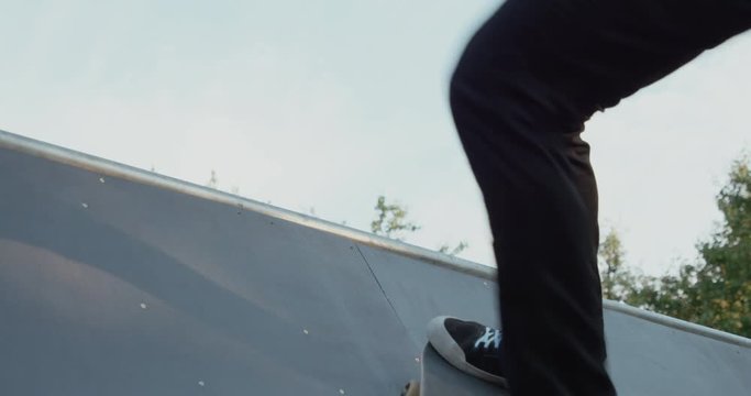 Young adult skateboarding halfpipe 4k super slow motion