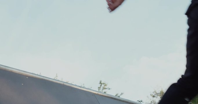 Young adult skateboarding halfpipe 4k super slow motion