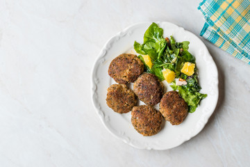 Homemade Salmon Meatballs Served with Orange Salad.