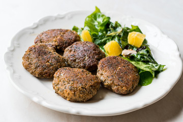 Homemade Salmon Meatballs Served with Orange Salad.