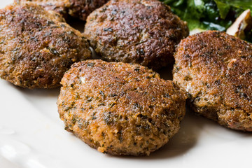 Homemade Salmon Meatballs Served with Orange Salad.
