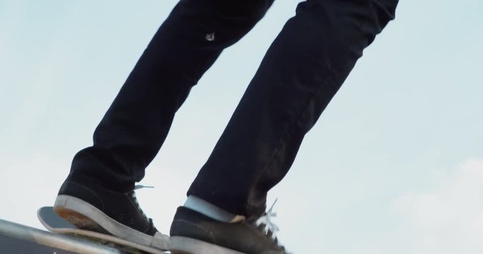 Young adult skateboarding halfpipe 4k super slow motion