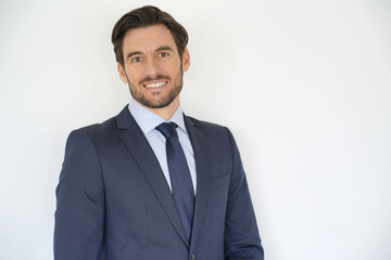 Isolated handsome businessman smiling in tailored suit