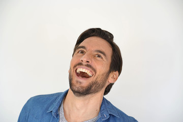 Obraz premium Portrait of carefree laughing handsome man on white background