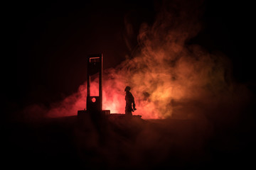 Horror view of Guillotine. Close-up of a guillotine on a dark foggy background.