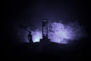 Horror view of Guillotine. Close-up of a guillotine on a dark foggy background.