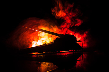 German canon on the train. World wars weapon resized artwork on table with dark toned foggy background. Battle scene.