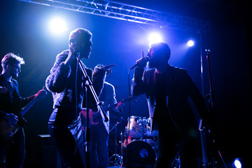 Musicians perform on stage in the club.