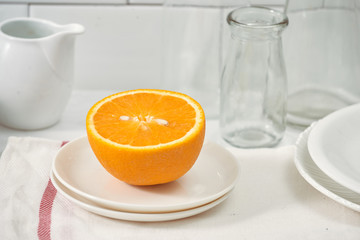 Orange in a dish on the table in the kitchen