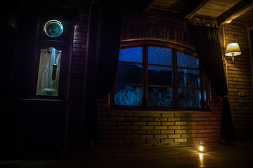 Night scene of stars seen through the window from dark room. Night sky inside dark room.