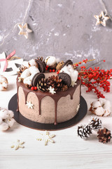Christmas  cake with flowers and chocolate. Wedding details - wedding cake.  Winter cake with cones