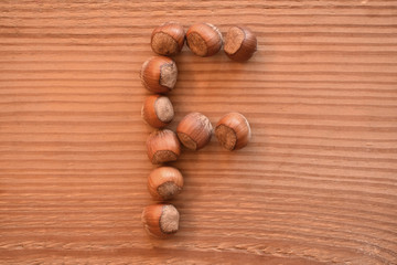 the letter F made with hazelnuts