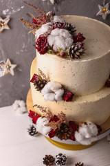 Christmas  cake with flowers and chocolate. Wedding details - wedding cake.  Winter cake with cones