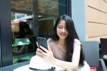 Happy asian woman holding smart phone
