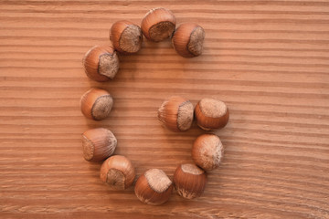 the letter G made with hazelnuts