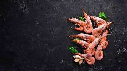 Large shrimp with lemon. Top view. Free space for your text. On the old background. - obrazy, fototapety, plakaty