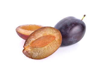 whole and half cut fresh prunes on white background