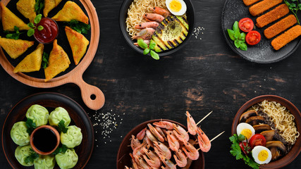 Asian food. On a black wooden background. Top view. Free copy space.