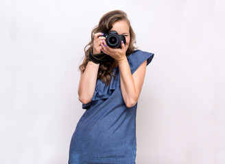 girl in blue dress holding cameras, camera lenses, photographer,
