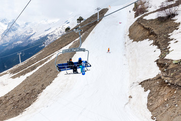 winter ski slope with skiers, cable car cabin, mountain resort in the Caucasus