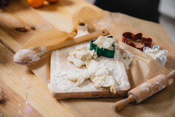 Dough, flour and mold for making Christmas cookies