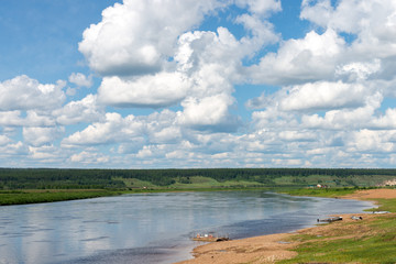 Rural landscape with yakutian village and Amga river at summer cloudy day in Yakutia, Siberia
