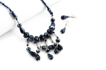 Faceted beads necklace with earrings on white background