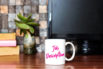 Writing showing Job Description on coffee cup