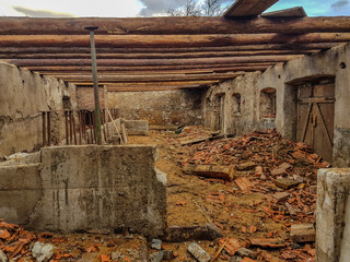 half destroyed barn with wooden beams