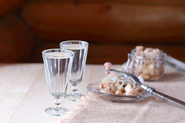 A glass of vodka and a snack from mushrooms.