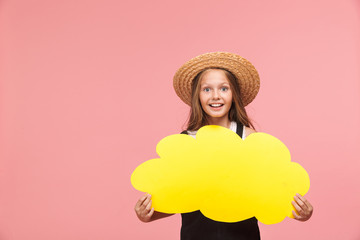 Portrait of a cheerful little girl wearing summer hat