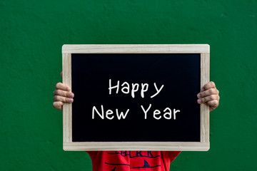 Happy new year  written blackboard by a children