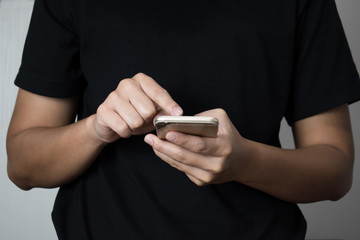 Men's hands are checking some on the phone.