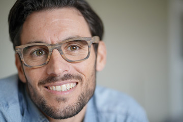 Portrait of casual handsome man wearing designer glasses