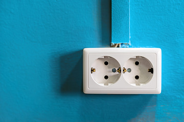 Double white rosette on blue painted wall. Copy space.